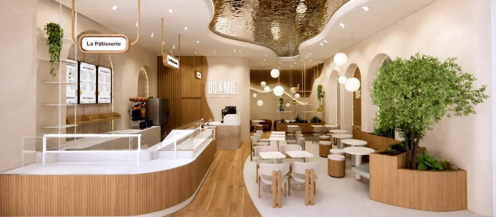 Rendu du futur BO&MIE de Koweït City : comptoirs cintrés en bois clair, plafond doré ondulé et salon café sous les arches